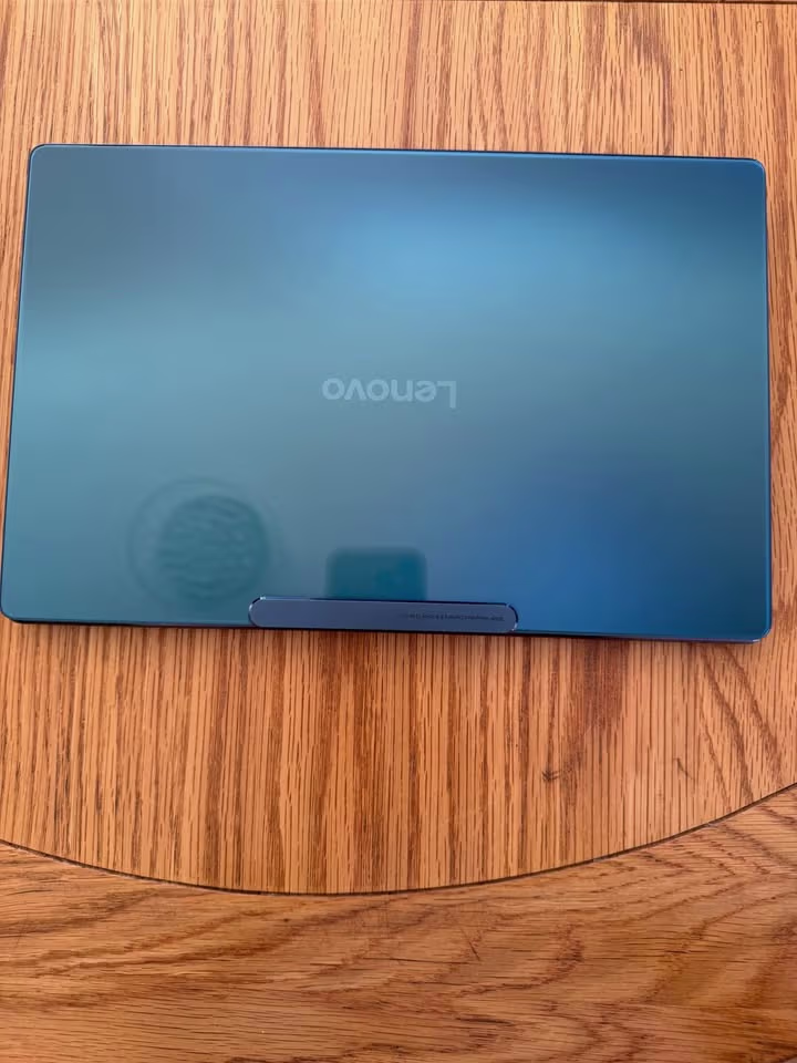 Lenovo Yoga Slim 9 Ultra 7 laptop closed lid backside view showing glossy 2.5D glass blue finish