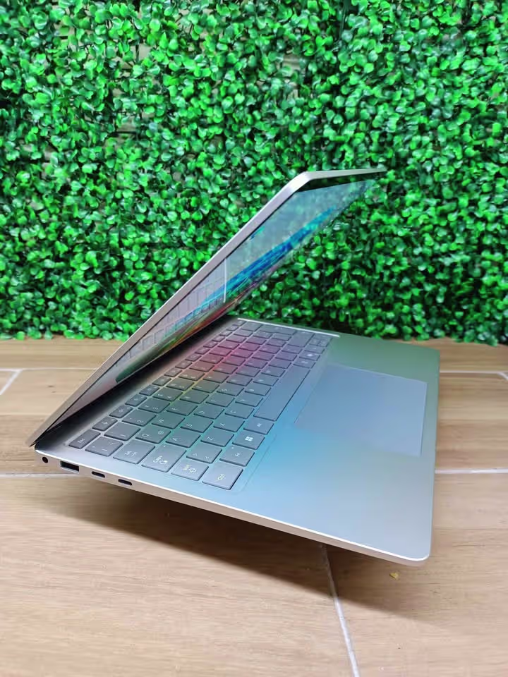 Microsoft Surface Laptop 7th Edition open at an angle, showing left side ports including headphone jack, USB-A port, and dual USB-C ports