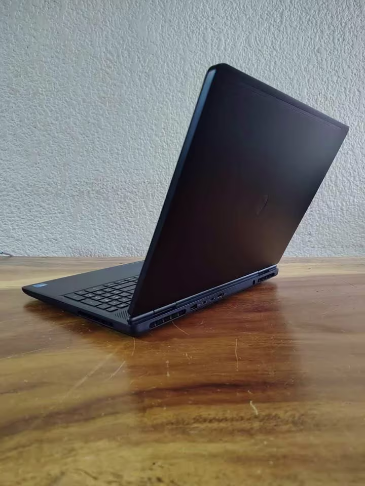 Alienware 16 Aurora gaming laptop with a dark chassis, visible keyboard, rear hinge, ventilation, and side I/O ports, highlighting its solid build quality and design.