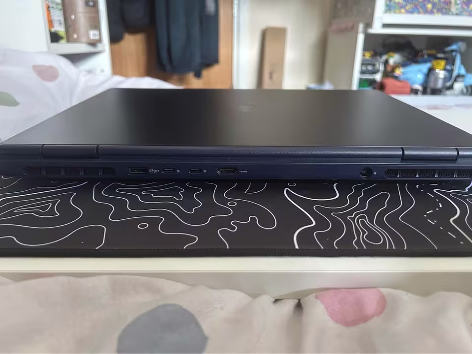 Alienware 16 Aurora Core 5 laptop rear side showing cooling ventilation, USB-A, USB-C, HDMI, and power ports