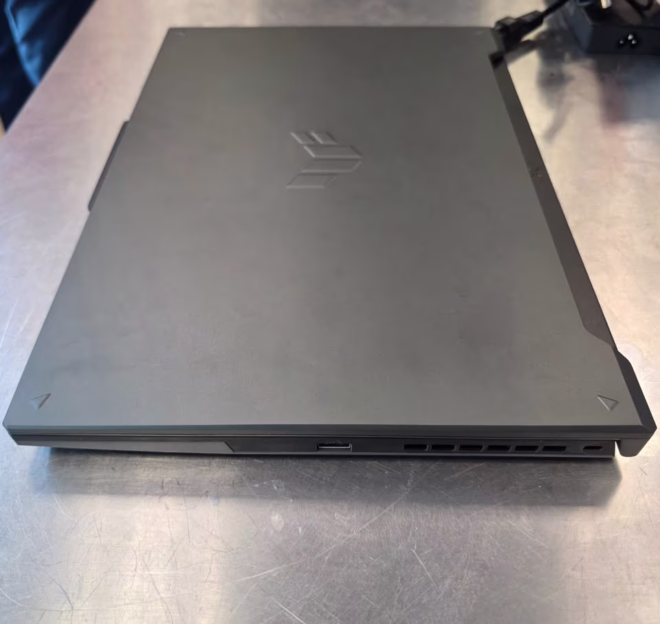 Close view of the right side of the ASUS TUF F16 gaming laptop, highlighting the USB A and C ports, cooling exhaust vents, and right-side I/O layout.