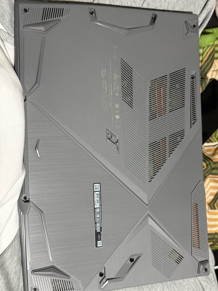 MSI Thin 15 gaming laptop underside showing multiple cooling and thermal ventilation vents, textured chassis, and MSI branding