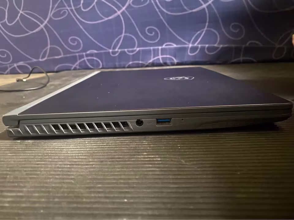 MSI Thin 15 Core i5 RTX 3050 laptop left side showing USB-A port and thermal ventilation grille