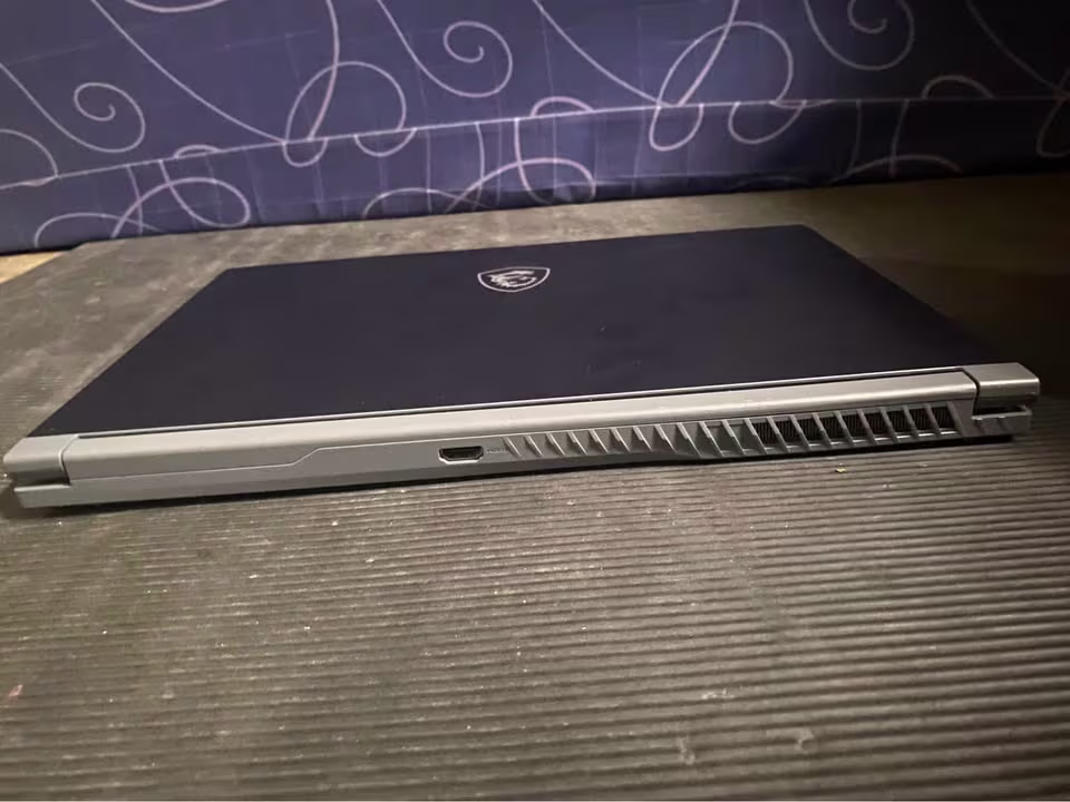 MSI Thin 15 Core i5 RTX 3050 laptop showing rear thermal vents and HDMI port